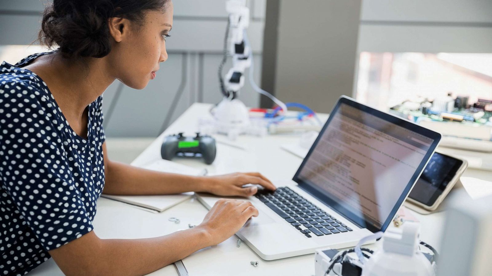 PHOTO: A woman is depicted using a computer in a robotics lab in an undated stock photo.