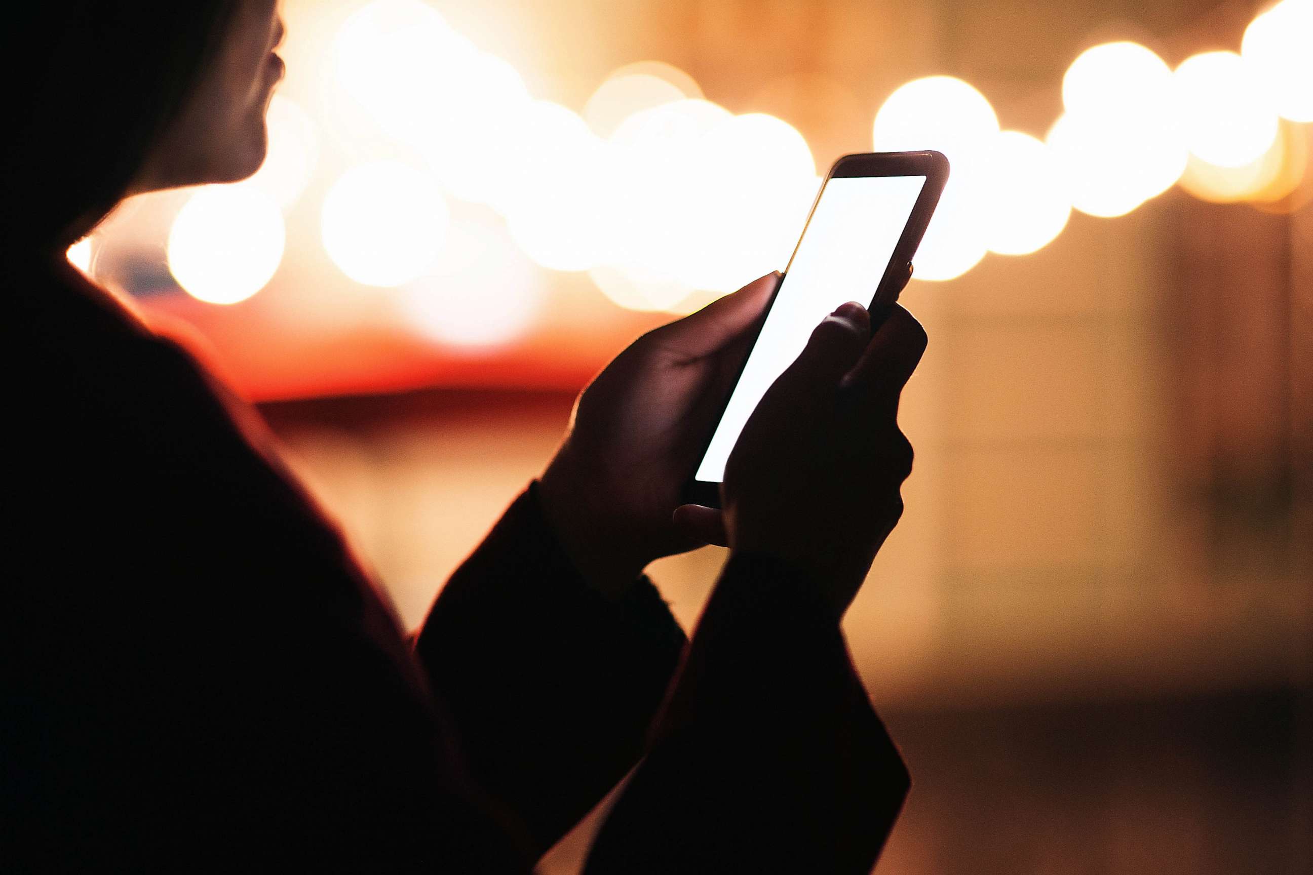 STOCK PHOTO: A woman looking at her phone