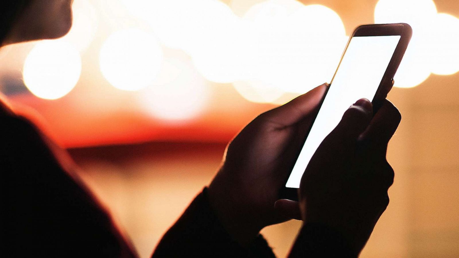 STOCK PHOTO: A woman looking at her phone