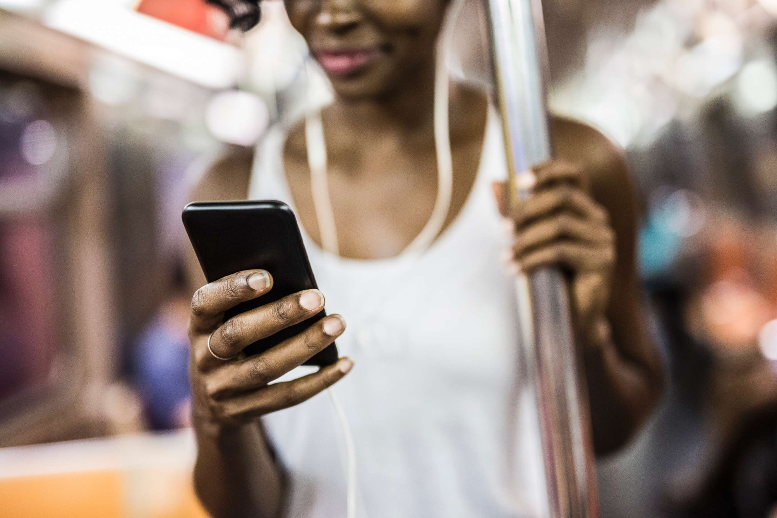 PHOTO: A woman looks at her phone on the train in New York in an undated stock photo.