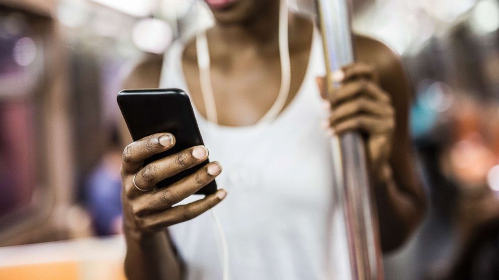 PHOTO: A woman looks at her phone on the train in New York in an undated stock photo.