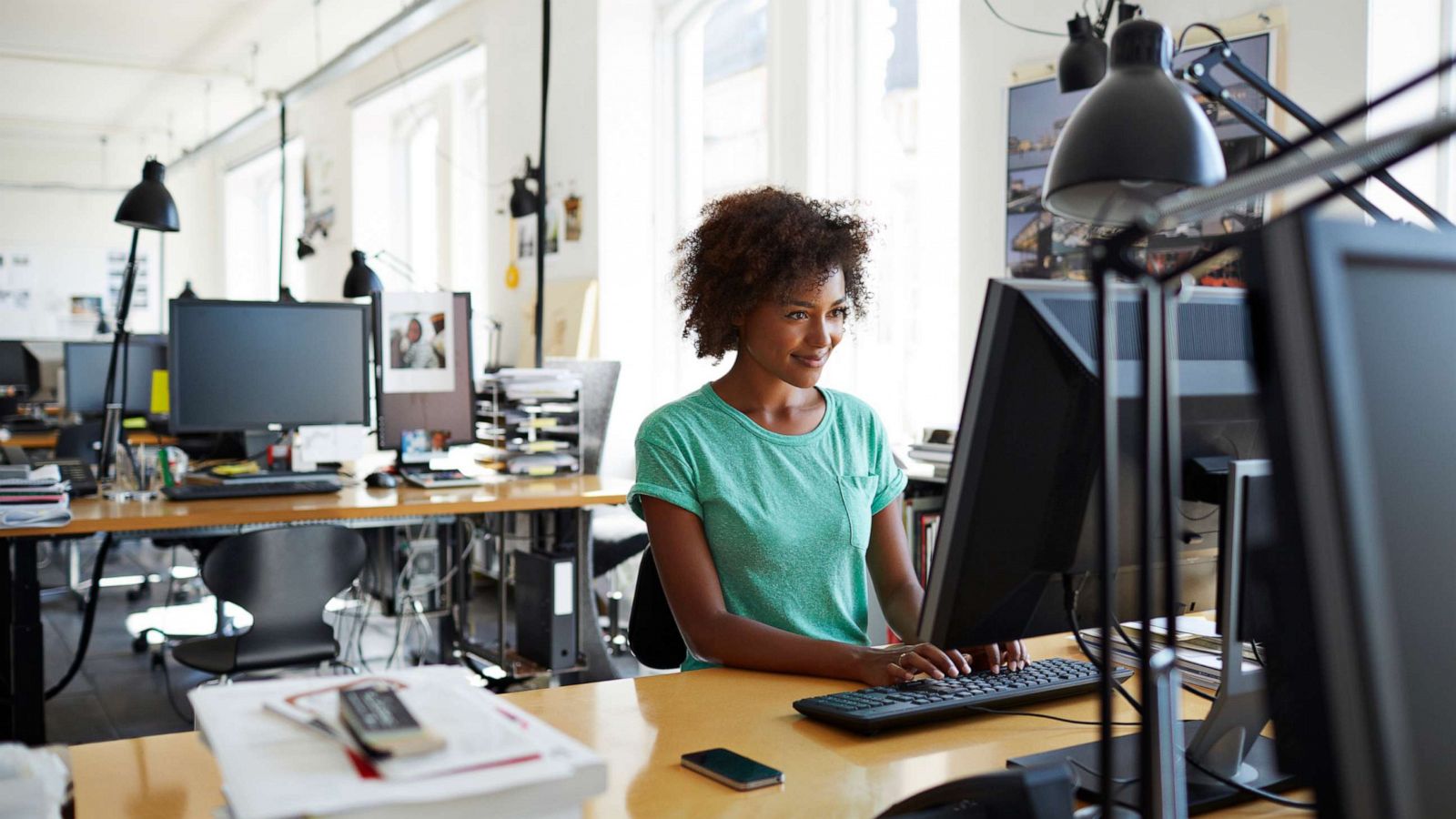 PHOTO: In this undated file photo, a woman sits at her desk at work.