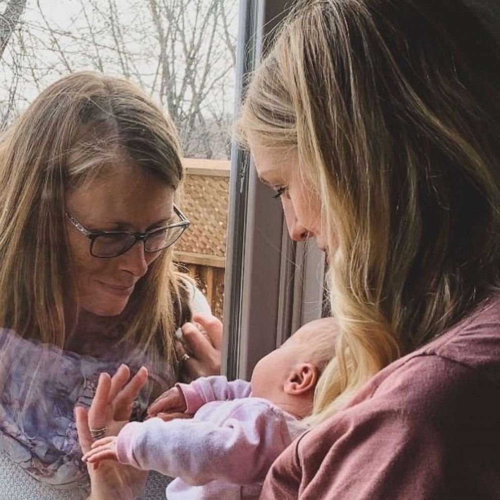 PHOTO: A Canada woman's powerful post on her mother meeting her newborn through a glass door is connecting parents who've experienced the same moment amid the novel coronavirus pandemic. 