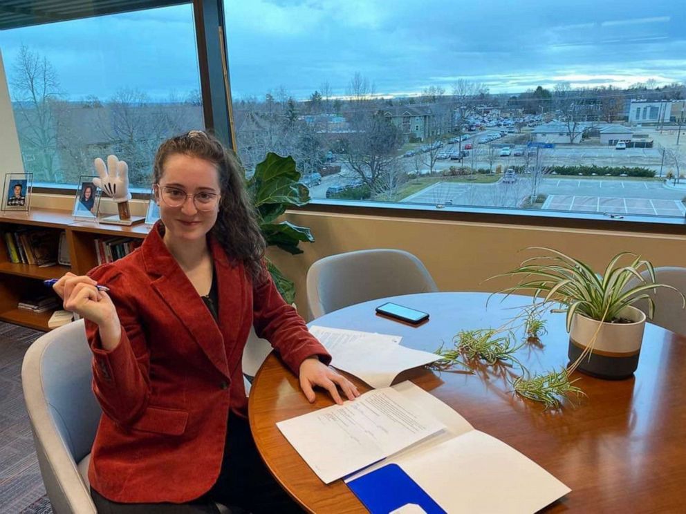 PHOTO: Ally Orr, a senior at Boise State University, signs paperwork creating the Women in STEM, Medicine and Law Scholarship.