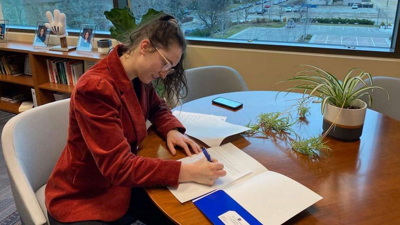 PHOTO: Ally Orr, a senior at Boise State University, signs paperwork creating the Women in STEM, Medicine and Law Scholarship.