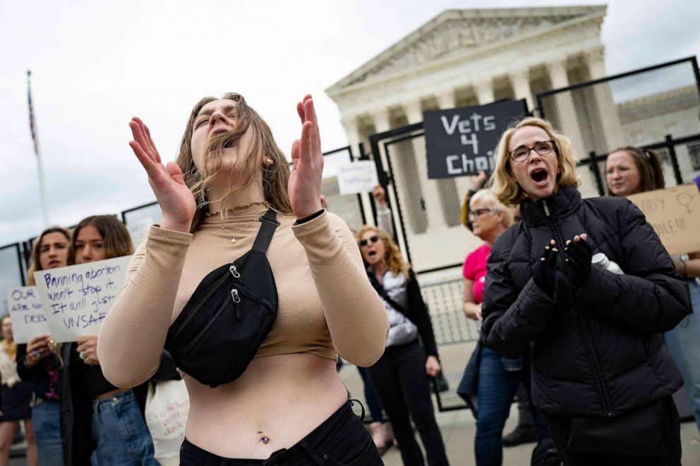 PHOTO: Abortion rights advocates demonstrator chant in front of un-scalable fence that stands around the US Supreme Court in Washington, May 5, 2022.