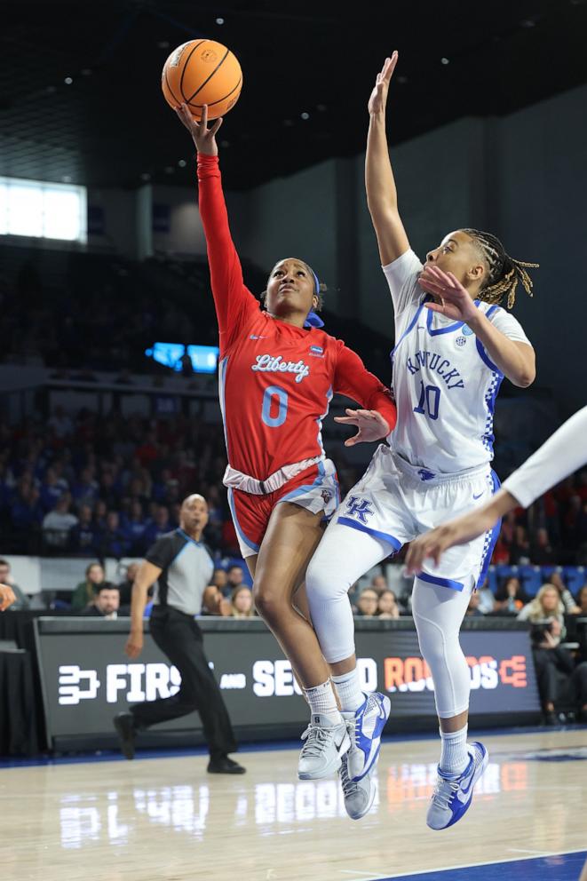 PHOTO: Jordan Hodges of the Liberty Lady Flames drives around Dazia Lawrence of the Kentucky Wildcats drives to the basket during the first half in the first round of the NCAA Women's Basketball Tournament, on March 21, 2025, in Lexington, Kentucky. 