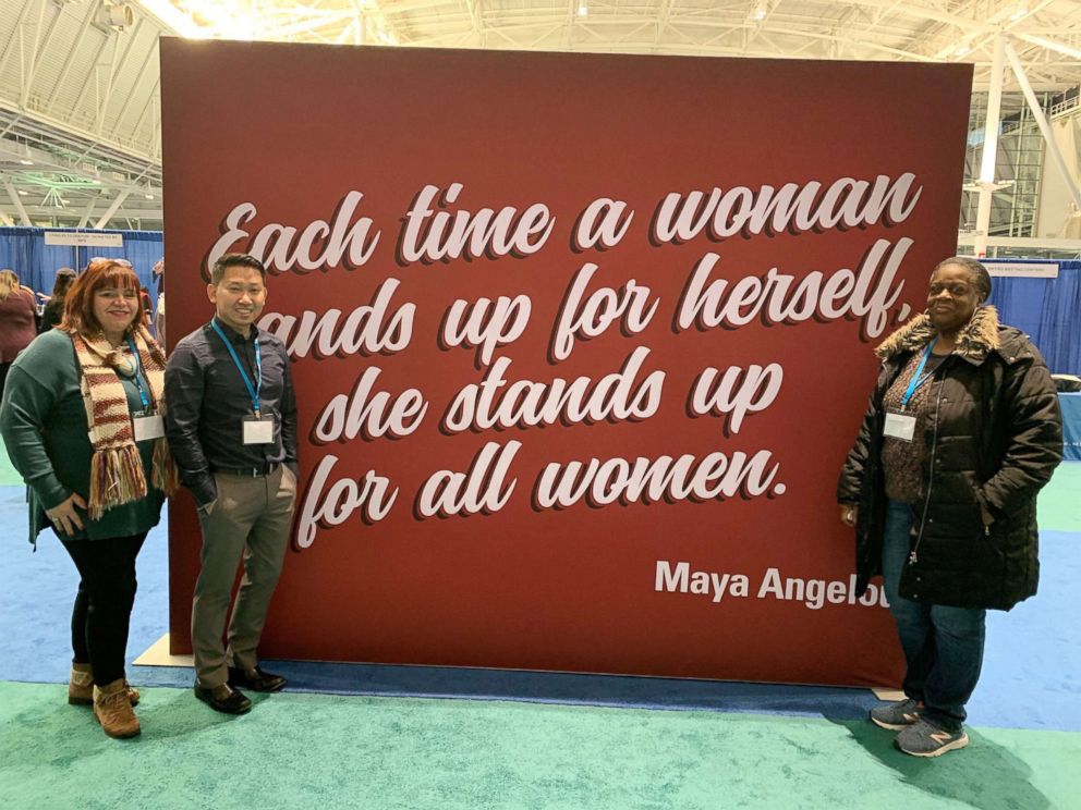 PHOTO: Kim Curran, far left, Jack Maniseng, and Shirley Edwards, right, pose at the 2018 Massachusetts Conference for Women in Boston.