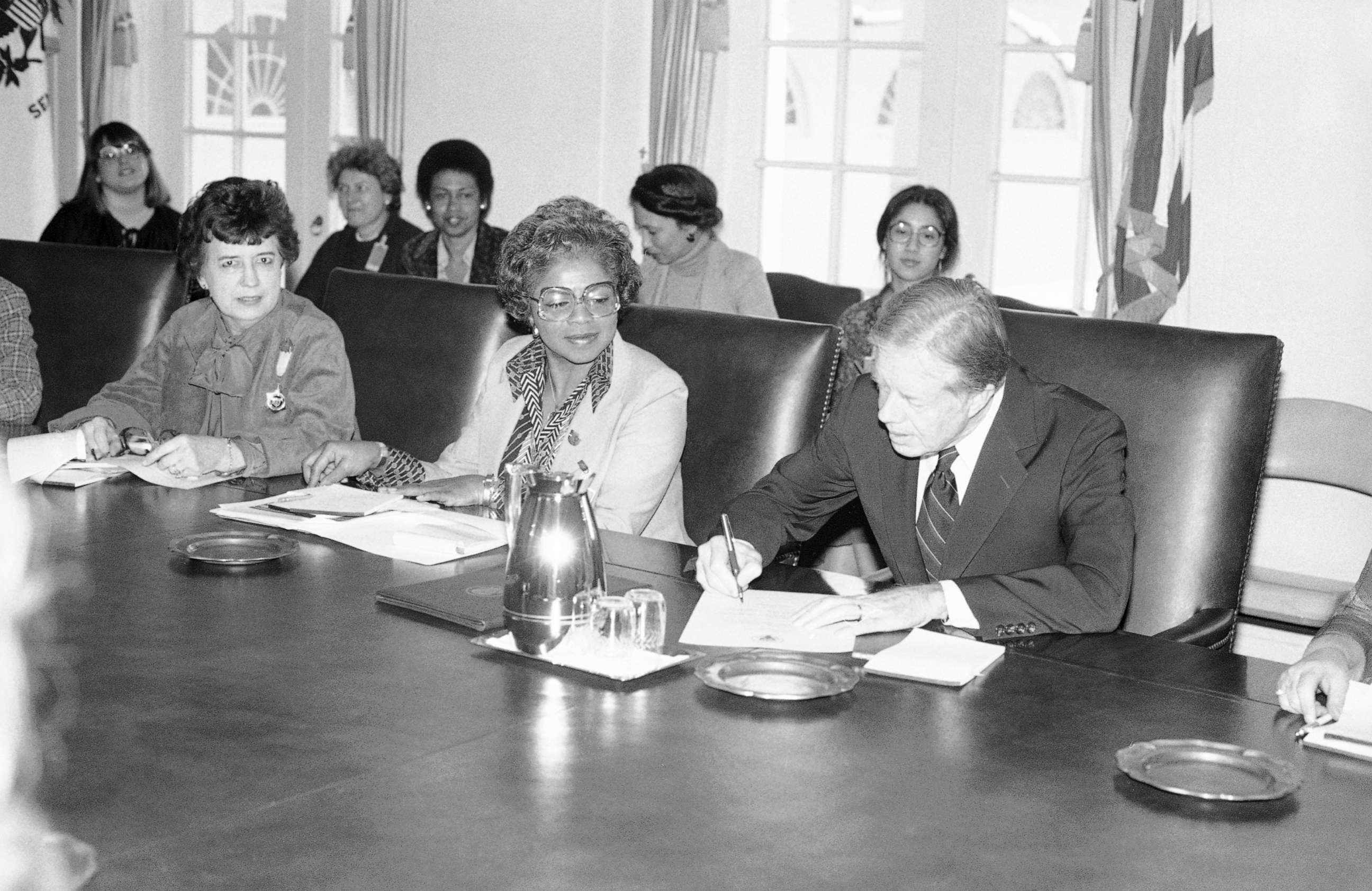 PHOTO: President Jimmy Carter signs document proclaiming March 2-8 "National Women's History Week" at the White House, Feb. 28, 1980. 
