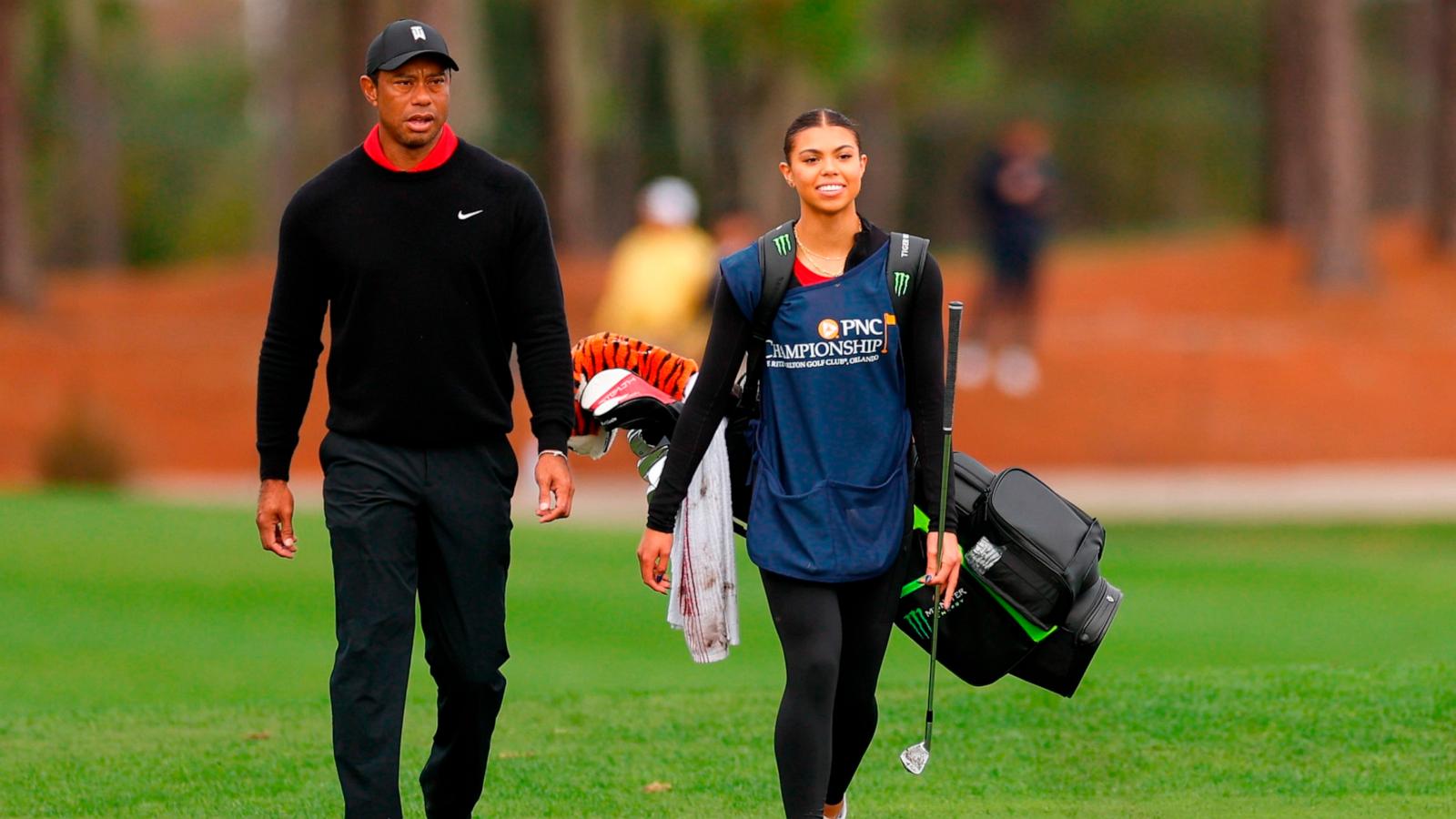 PHOTO: Tiger Woods of the United States and daughter and caddie, Sam Woods, walk on the fifth hole during the final round of the PNC Championship at The Ritz-Carlton Golf Club on December 17, 2023 in Orlando, Florida.