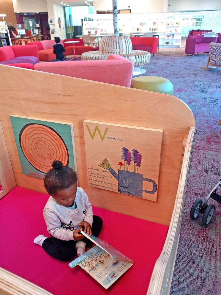 PHOTO: Witcher's one-year-old child takes a look at a picture book in the carrel's play area. A custom carrel at a Virginia library features a play area for babies and toddlers at Henrico County's Fairfield Area Library.