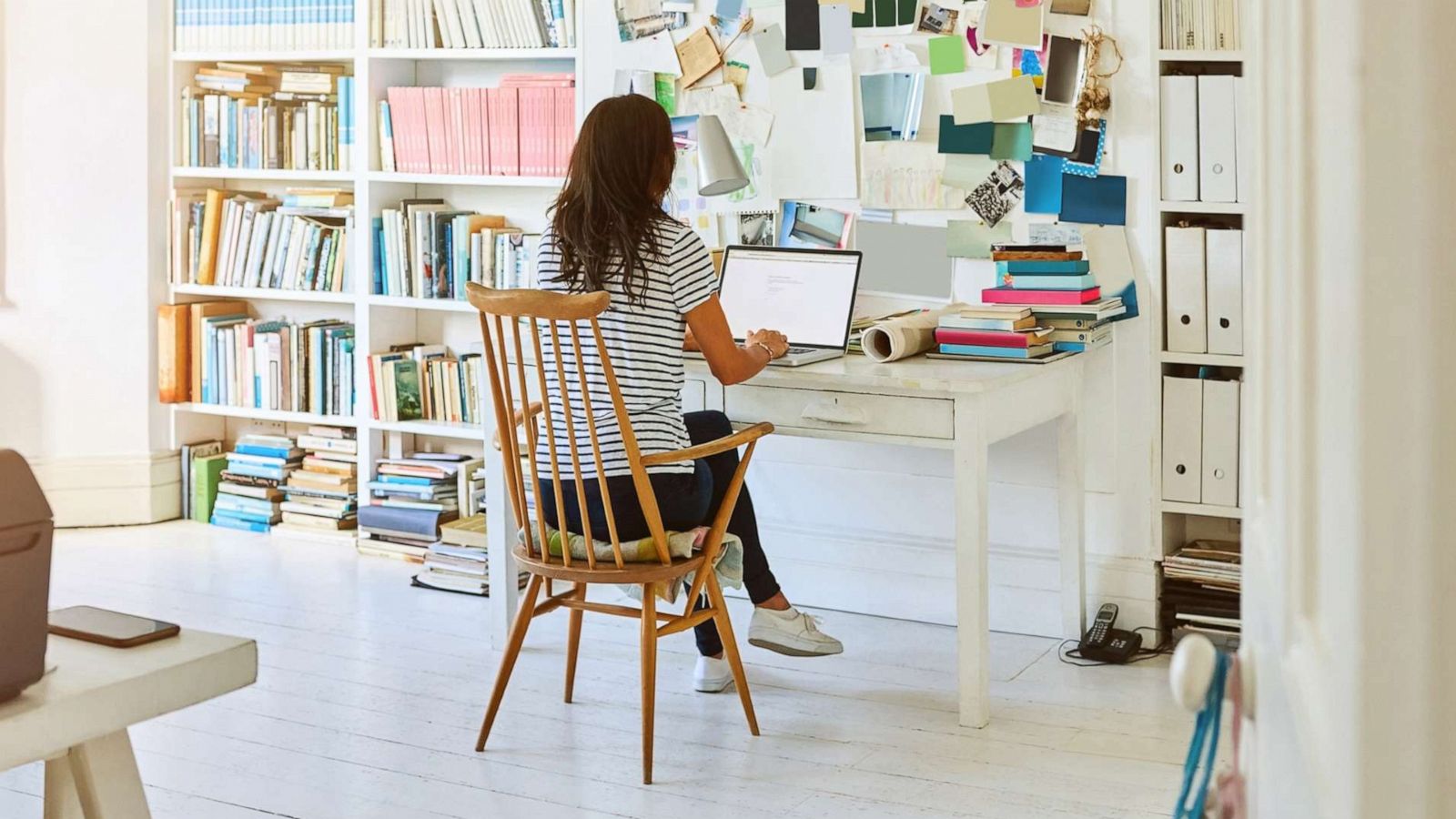 PHOTO: An undated stock photo depicts a woman sitting in home office and working on laptop.