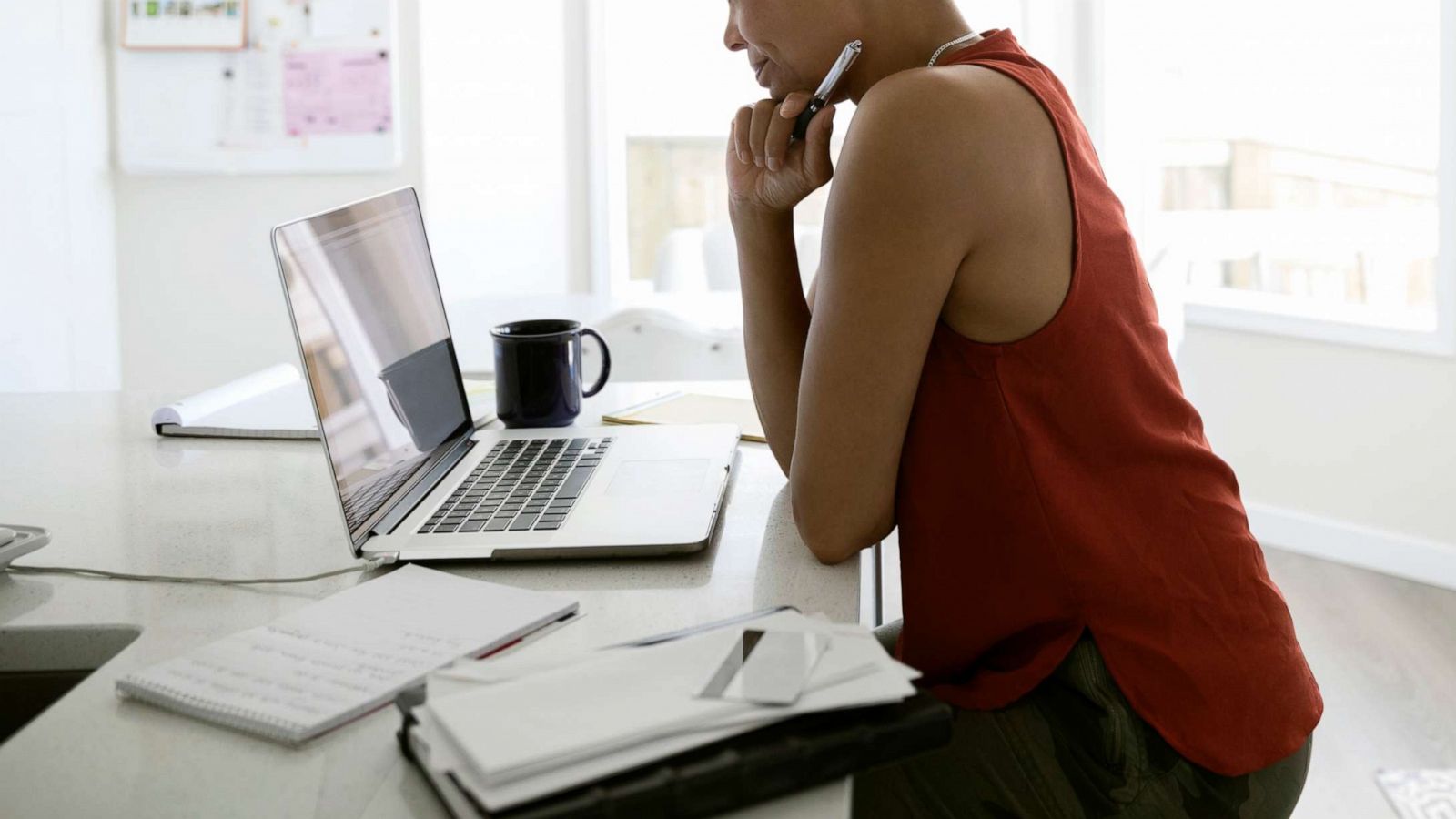 PHOTO: A woman works at a stand-up desk in this stock photo.