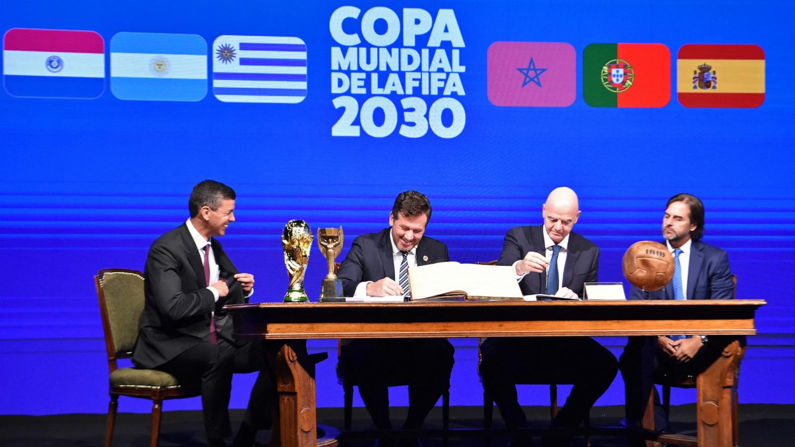 PHOTO: Conmebol's President Alejandro Dominguez and FIFA President Gianni Infantino accompanied by Paraguay's President Santiago Pena and Uruguay's President Luis Lacalle sign a book of minutes of the 2030 World Cup in Luque, Paraguay, April 11, 2024.
