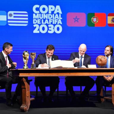 PHOTO: Conmebol's President Alejandro Dominguez and FIFA President Gianni Infantino accompanied by Paraguay's President Santiago Pena and Uruguay's President Luis Lacalle sign a book of minutes of the 2030 World Cup in Luque, Paraguay, April 11, 2024.