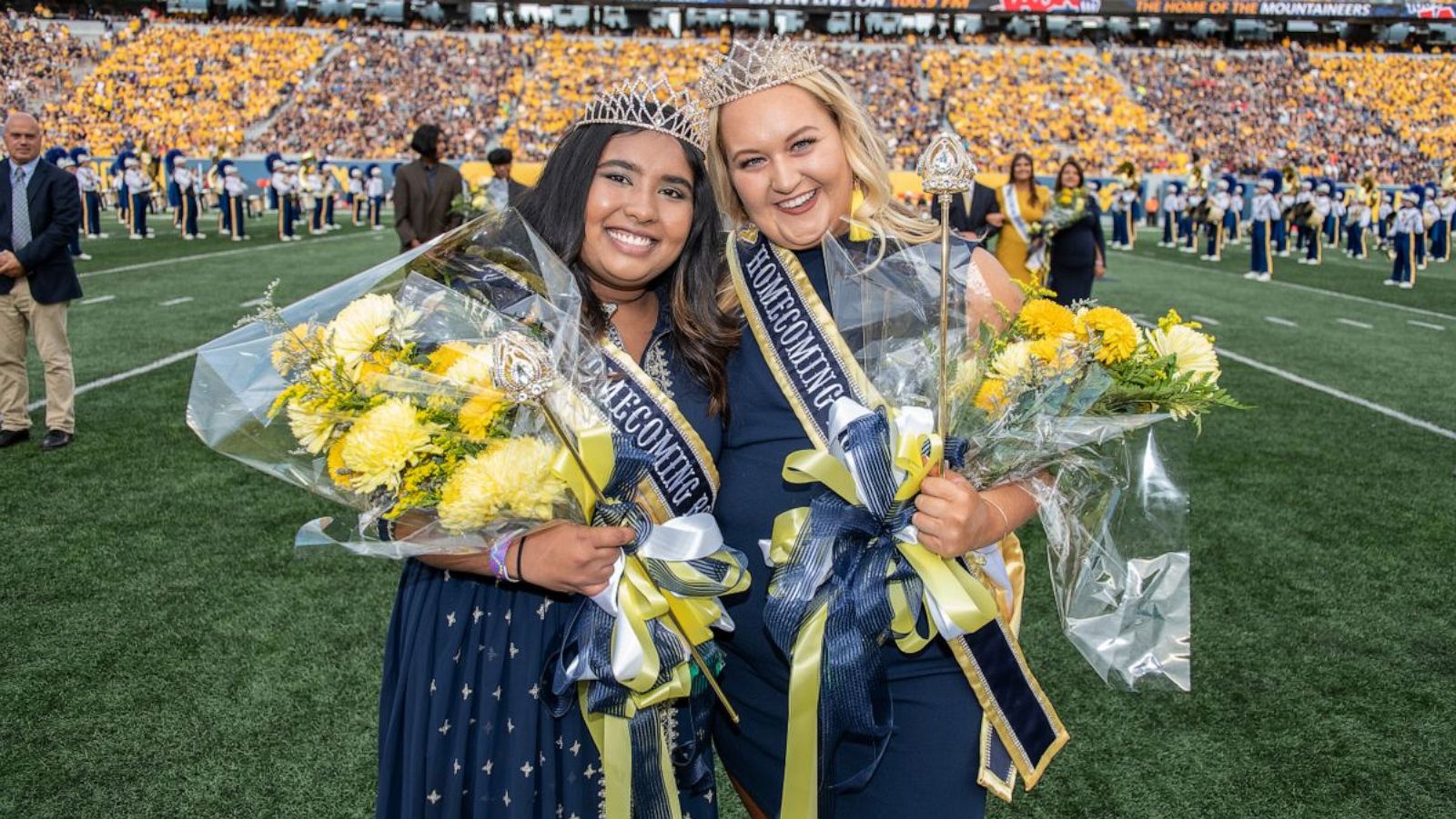 PHOTO: Raimah Hossain (left) and Kylie A. Parker (right) are honored as the 2021 Homecoming Royalty during halftime of West Virginia University's football game against Texas Tech on Oct. 2, 2021.