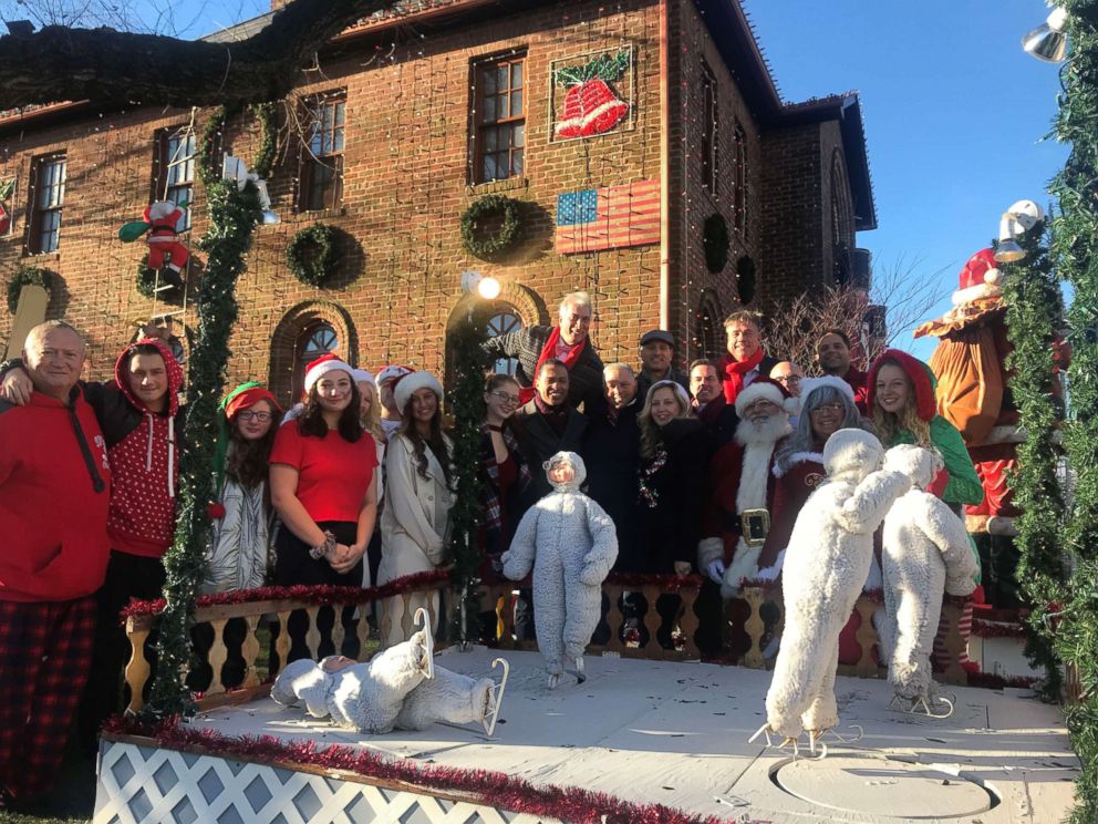 PHOTO: Joe Mure with his family and friends in front of his holiday display at their Rockaway Beach home. 