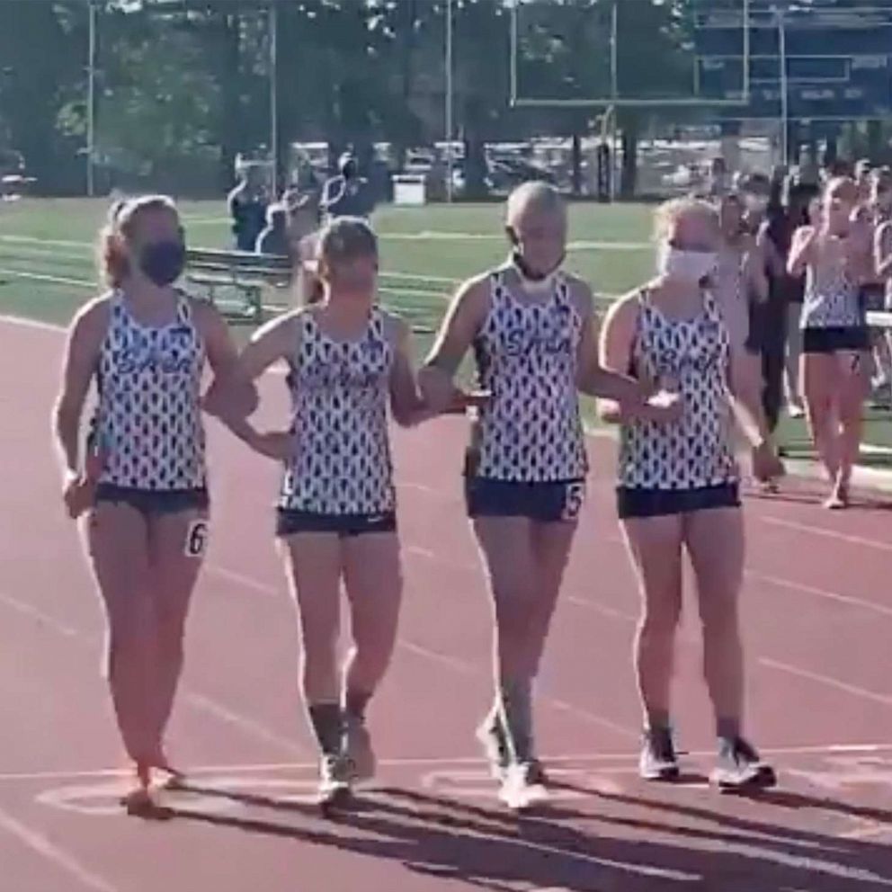 VIDEO: High school runner with cancer crosses finish line with her team at her side 