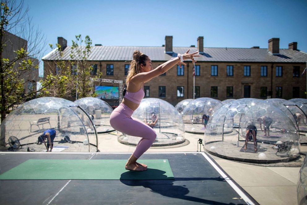 PHOTO: Yoga instructor Kay Ghajar leads an outdoor yoga class by LMNTS Outdoor Studio in Toronto, June 21, 2020.