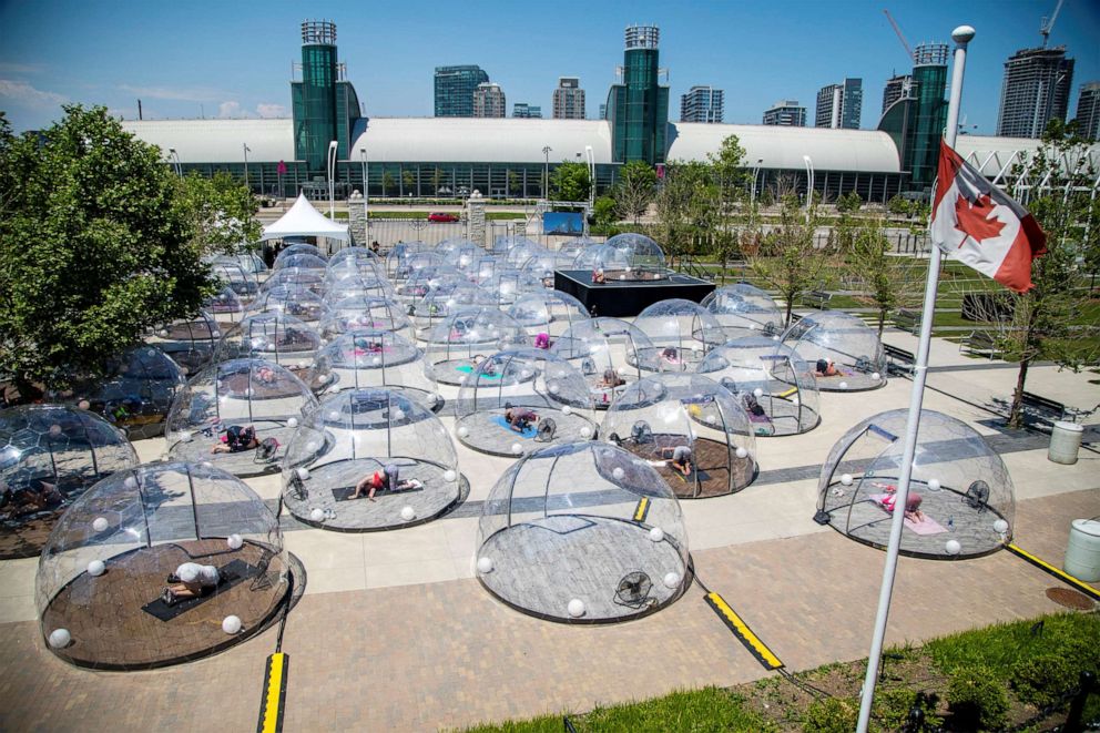 PHOTO: People participate in an outdoor yoga class held in domes to facilitate social distancing and proper protocols to prevent the spread of coronavirus, in Toronto, June 21, 2020.