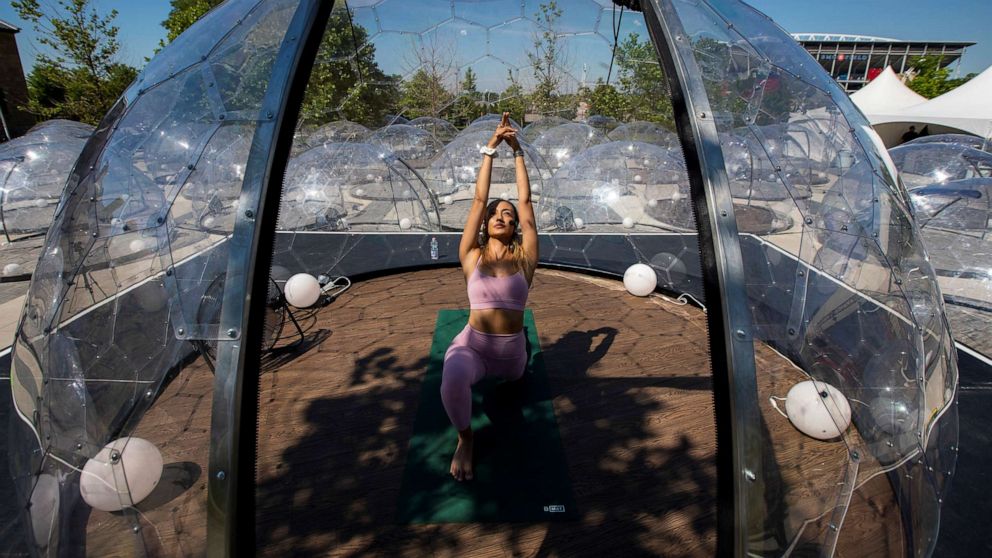 PHOTO: Yoga instructor Kay Ghajar leads an outdoor yoga class by LMNTS Outdoor Studio in Toronto, June 21, 2020.