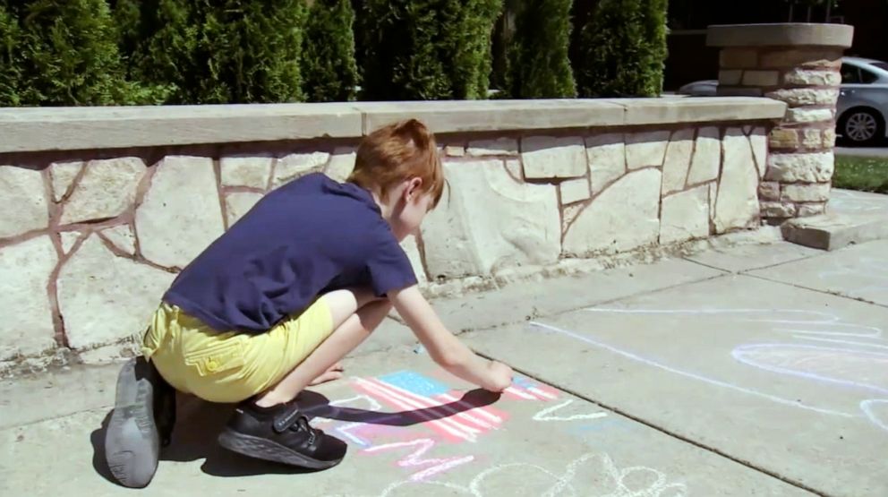 PHOTO: Aiden Kelley, 9, marched and made chalk drawings asked his neighbors to treat each other with respect and kindness in support of the Black Lives Matter movement outside his Chicago home in an undated handout photo.