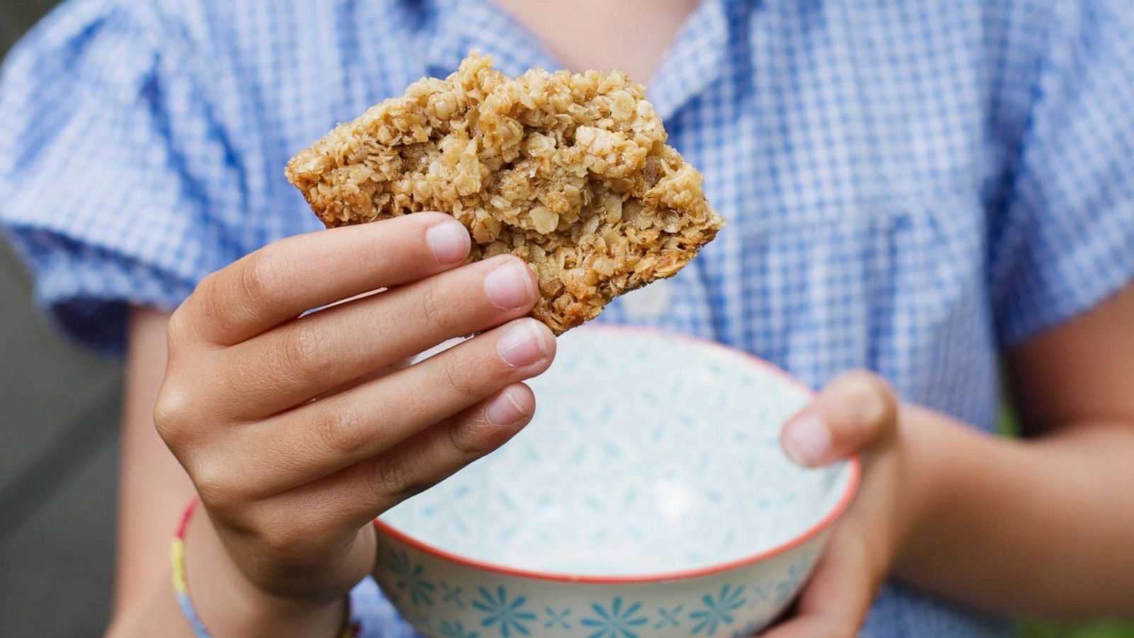 PHOTO: In this undated stock photo, a young girl eats a granola bar.