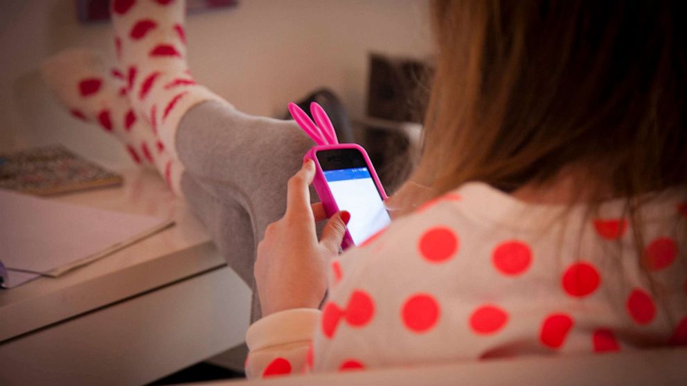 PHOTO: A young girl is seen using a smartphone in this stock image.