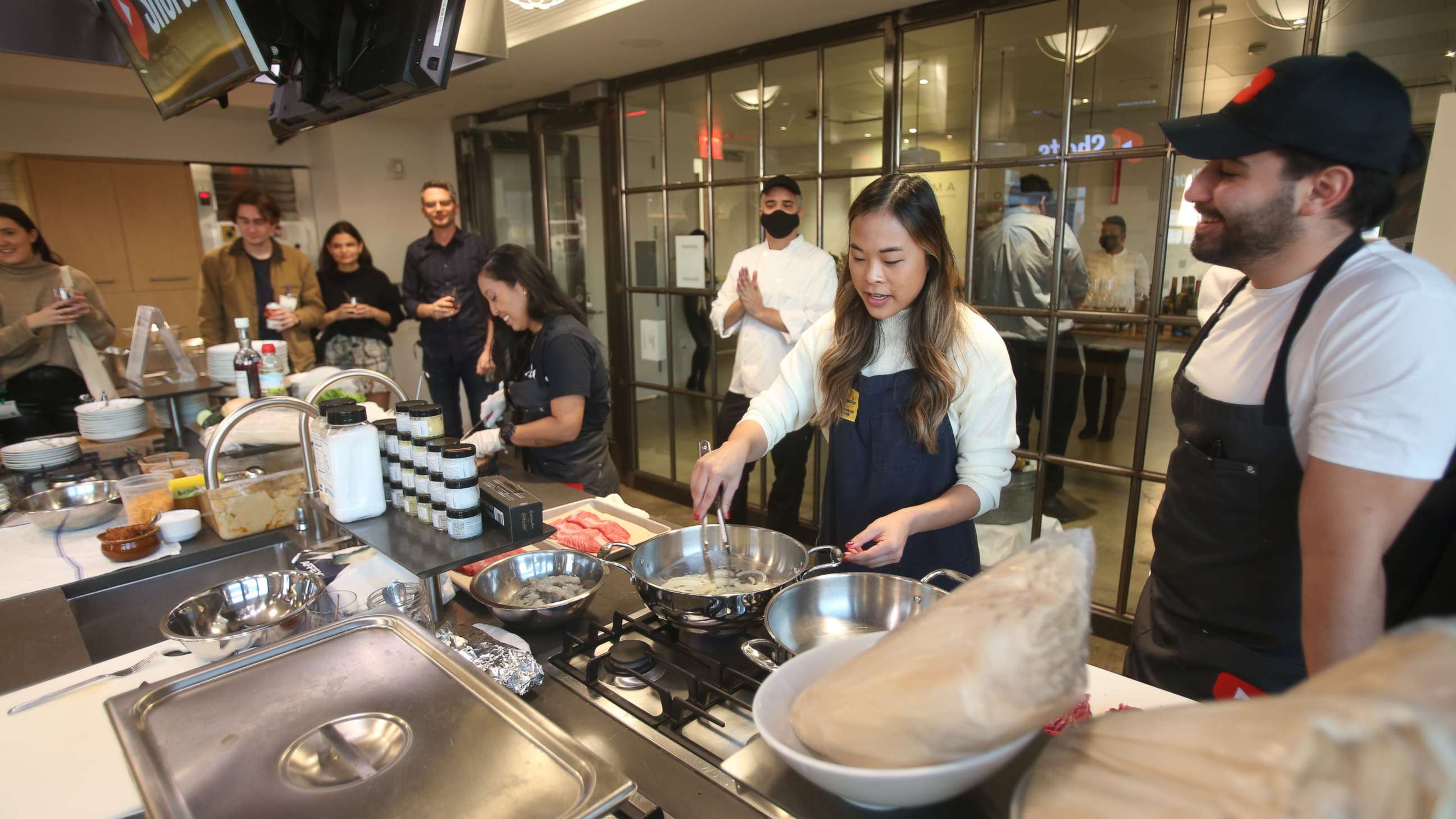 PHOTO: Joanne Molinaro, Lisa Nguyen and Matt Broussard cook their Thanksgiving dishes together.