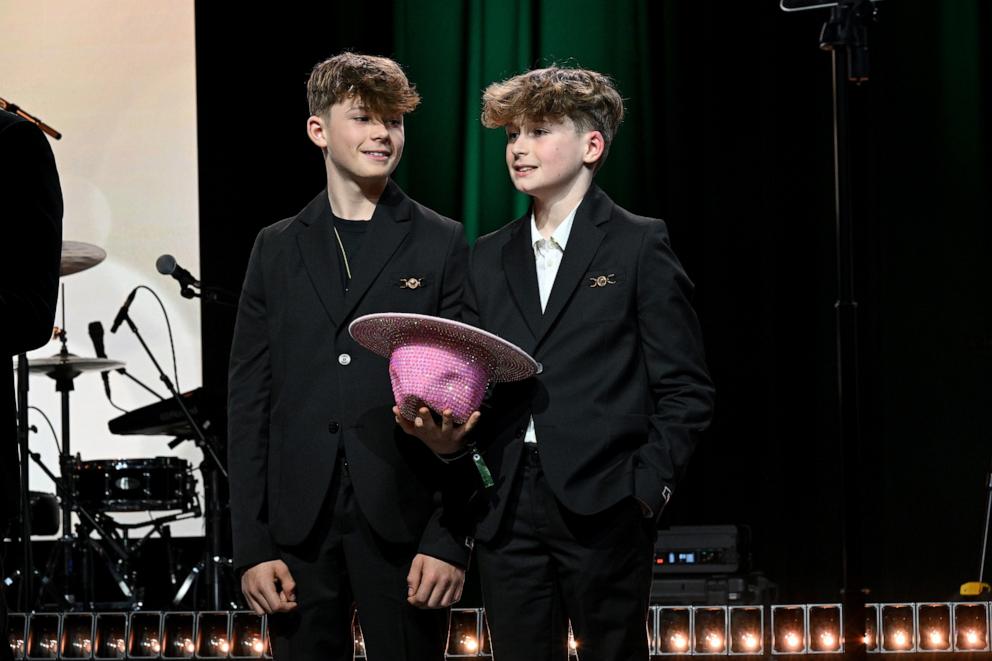 PHOTO: Zachary Furnish-John and Elijah Furnish-John speak onstage during Elton John AIDS Foundation's 33rd Annual Academy Awards Viewing Party on March 02, 2025 in West Hollywood, California.