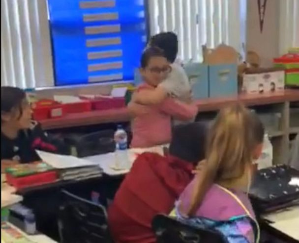 PHOTO: Rumari Zalez, 11, is seen on April 5 hugging a classmate after revealing he has autism. 