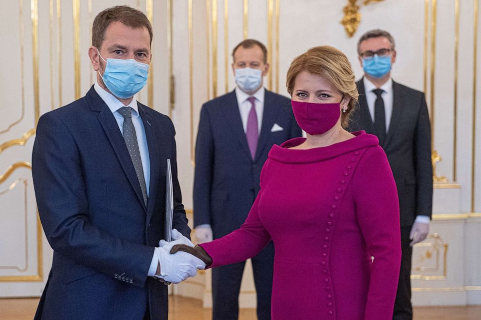 PHOTO: Newly appointed Slovak Prime Minister Igor Matovic shakes hands with Slovakian President Zuzana Caputova during a swearing in ceremony of the new four-party coalition government, March 21, 2020, at the Presidential palace in Bratislava.