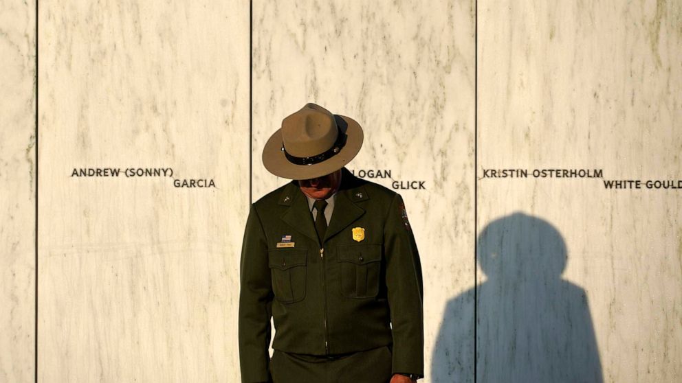 PHOTO: A National Park Service ranger stands in front of the Wall of Names at the Flight 93 National Memorial in Shanksville, Pa. before a Service of Remembrance, Sept. 11, 2021.