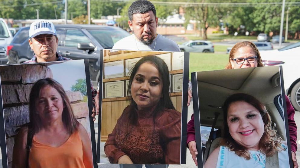 PHOTO: Family members hold up photographs of loved ones who have not been found by Sunday, Sept. 29, 2024 in the aftermath of the flooding caused by Tropical Storm Helene in Erwin. Tenn. 