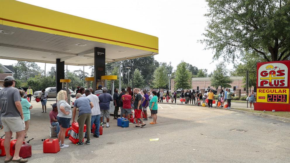 PHOTO: Residents wait in line with gas cans at a Gas Plus gas station in the aftermath of Hurricane Helene in North August, SC, Sept. 29, 2024.