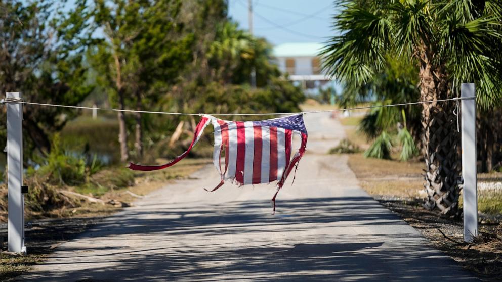 PHOTO: A tattered American flag hangs on a rope on a now closed road in the aftermath of Hurricane Helene, in Jena, Fla., Sept. 29, 2024. 