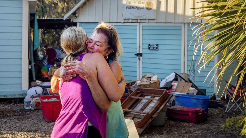 PHOTO: Amber Bertrand of Williston, hugs Tina DiLibero goodbye after Bertrand helped salvage some of DiLibero's belongings in the wake of Hurricane Helene in Steinhatchee, Fla., Sept. 28, 2024.   