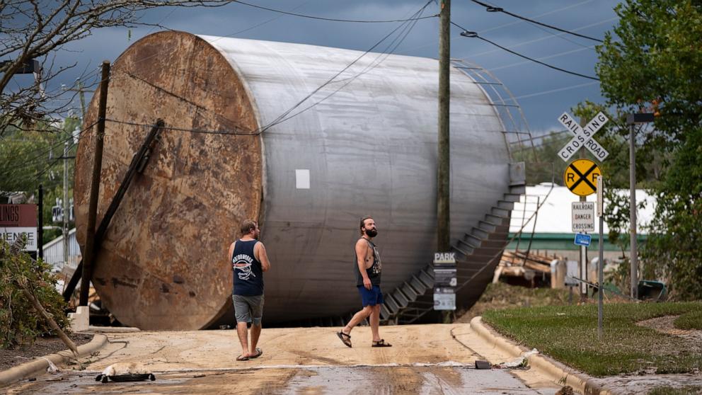 PHOTO: Men inspect the damage from flooding in the Biltmore Village in the aftermath of Hurricane Helene in Asheville, NC, Sept. 28, 2024.