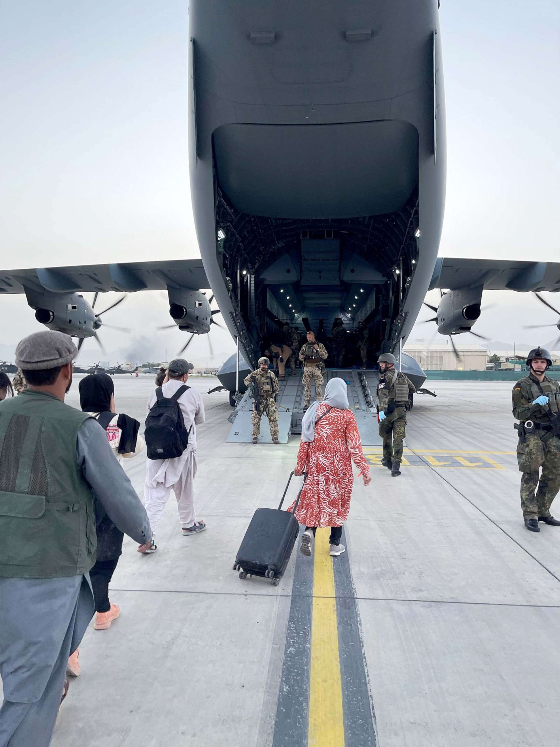 PHOTO: PHOTO :Evacuees from Afghanistan board an aircraft of the German Air Force Luftwaffe in Kabul, Afghanistan, Aug. 18, 2021. 
