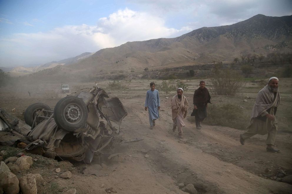 PHOTO: People survey the scene of a road side bomb blast in Achin district of Nangarhar province, Afghanistan, Oct. 21, 2018