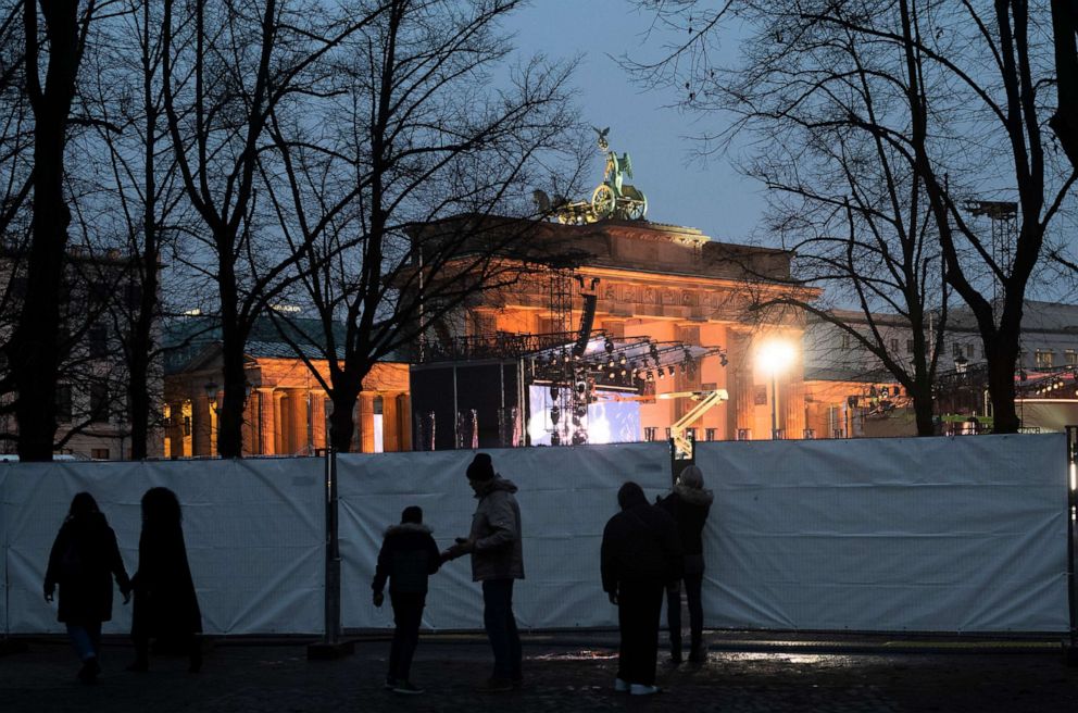 PHOTO: People gather near the the Brandenburg Gate in Berlin, Germany, Dec. 29, 2021, where a stage is set for the New Year's Eve celebration. The traditional TV show at the Brandenburg Gate will held without an audience.