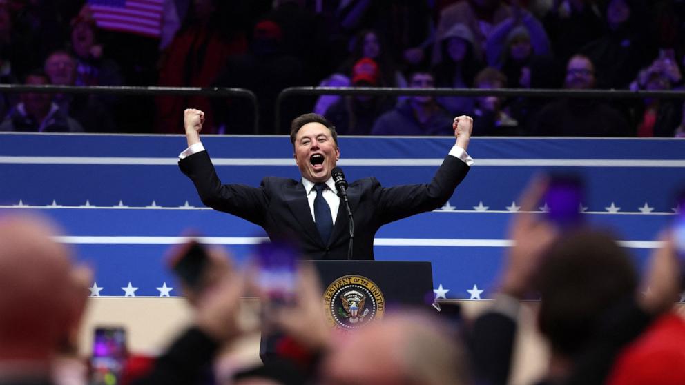 PHOTO: Tesla CEO and X owner Elon Musk gestures on stage as he prepares to speak inside the Capital One Arena on the inauguration day of Donald Trump's second Presidential term, in Washington, DC, Jan. 20, 2025. 