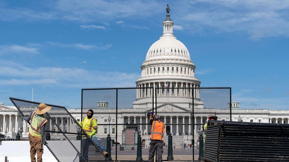 PHOTO: Workers remove the fence surrounding the Capitol building, July 10, 2021.