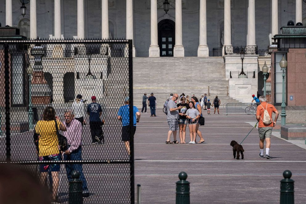PHOTO: Members of the public walk freely on the Capitol plaza as workers remove security fencing surrounding the Capitol, July 10, 2021. 