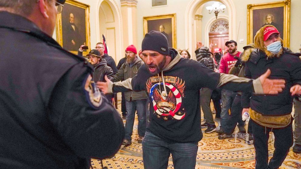 PHOTO: Douglas Jensen from Des Moines, Iowa and other protesters confront U.S. Capitol Police in the hallway outside of the Senate chamber in Washington, Jan. 6, 2021.