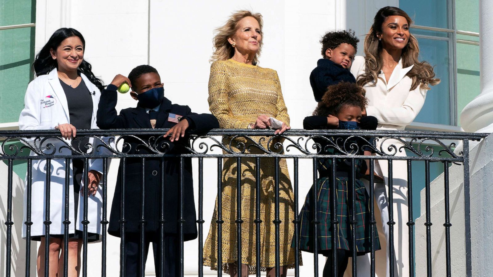 PHOTO: First lady Jill Biden, singer Ciara, right, with her children and pediatrician Hina Talib watch from the White House balcony as President Joe Biden, leaves the White House on Marine One in Washington, Nov. 17, 2021.