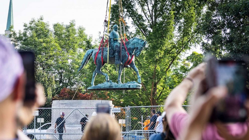 PHOTO: Workers remove the statue of Confederate General Robert E. Lee in Market Street Park in Charlottesville, Va., July 10, 2021. 