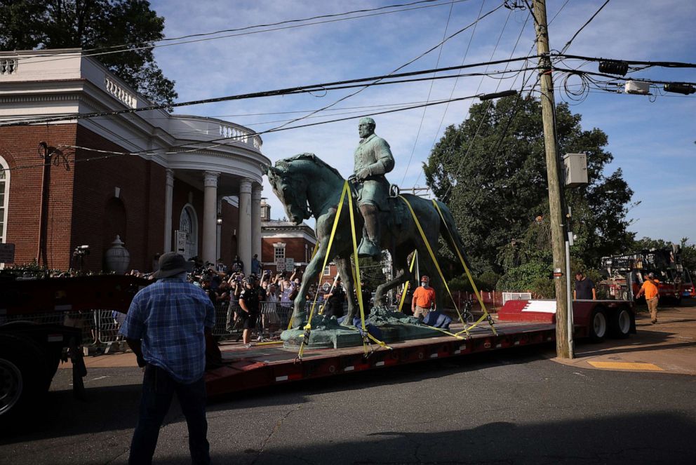 PHOTO: A flatbed truck carries a statue of Confederate General Robert E. Lee from the Market Street Park in Charlottesville, Va., July 10, 2021. 