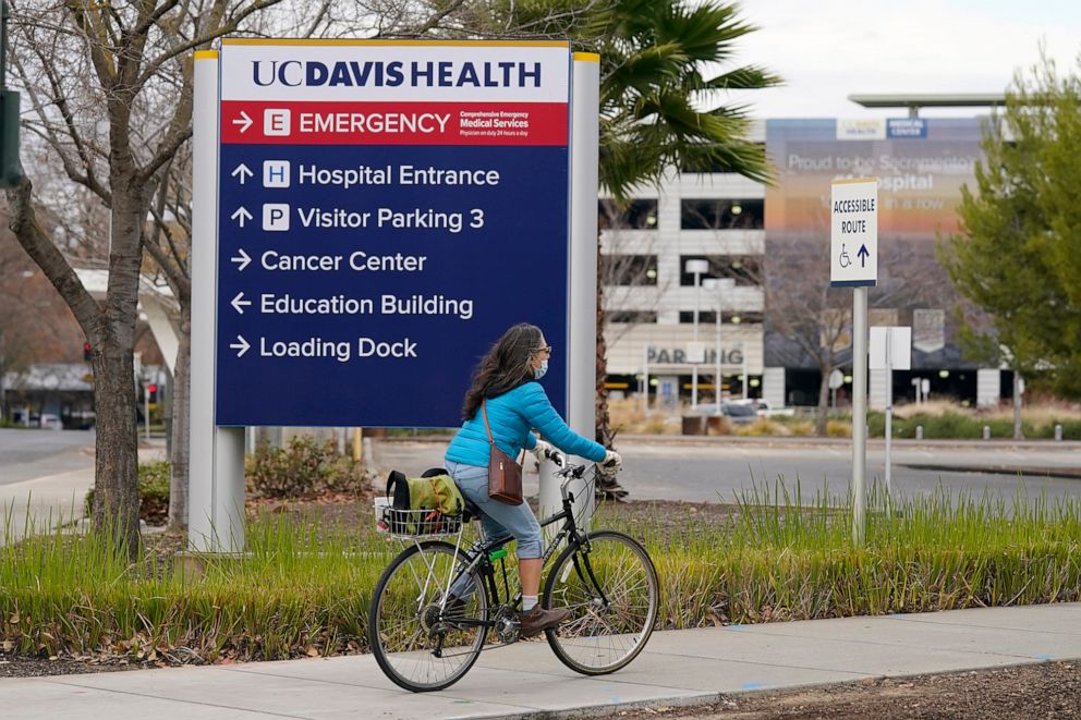 PHOTO: A bicyclist rides near the University of California, Davis Medical center in Sacramento, Calif., Dec. 11, 2020.