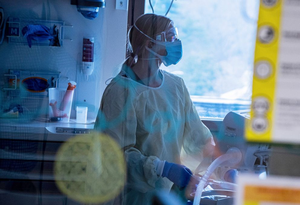 PHOTO: A nurse at the University of Vermont Medical Center Pediatric Intensive Care Unit  cares for a Covid-19 positive child receiving care in Burlington, Vt., Dec. 2, 2021.